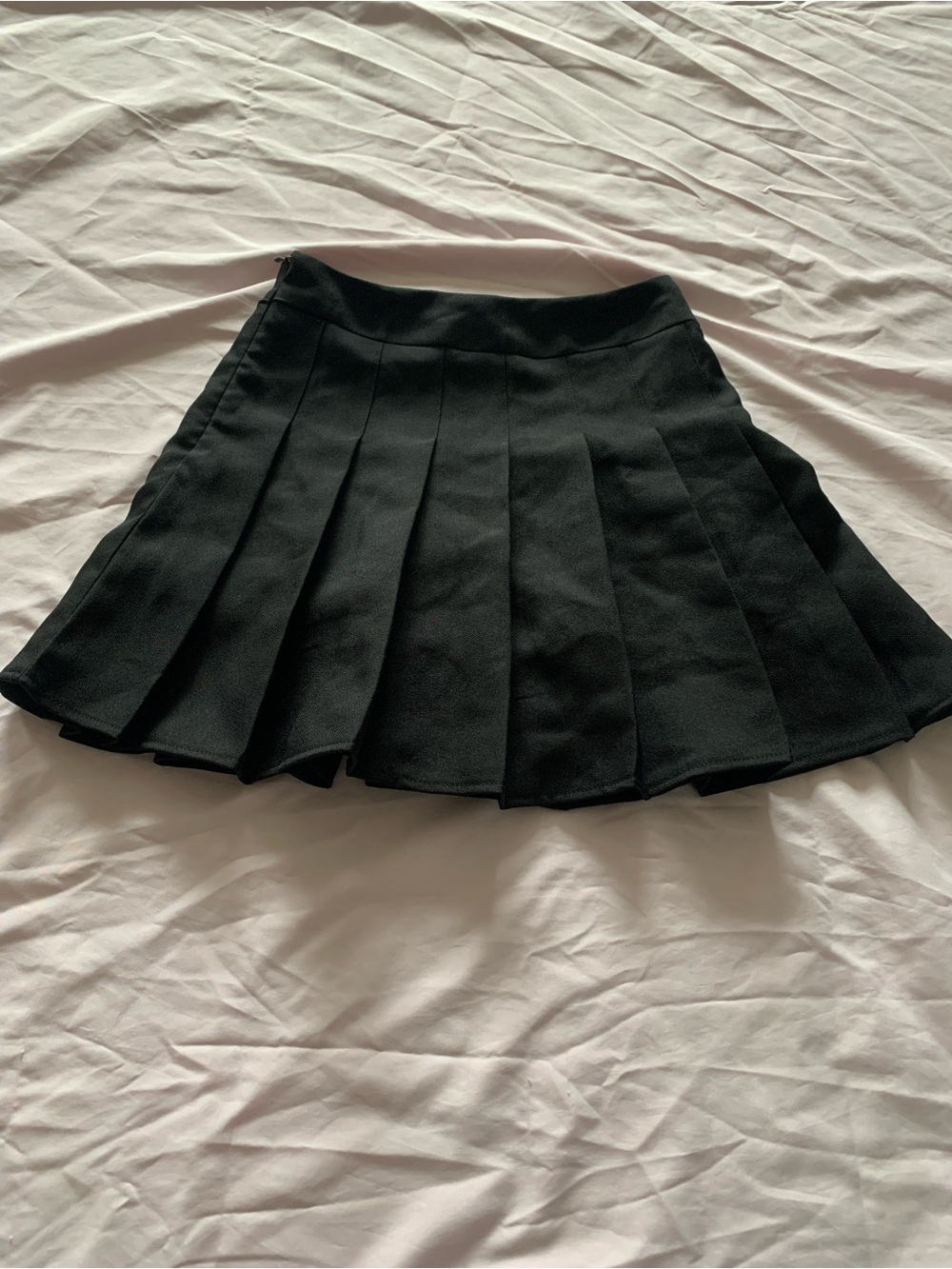 Black pleated tennis mini skirt.